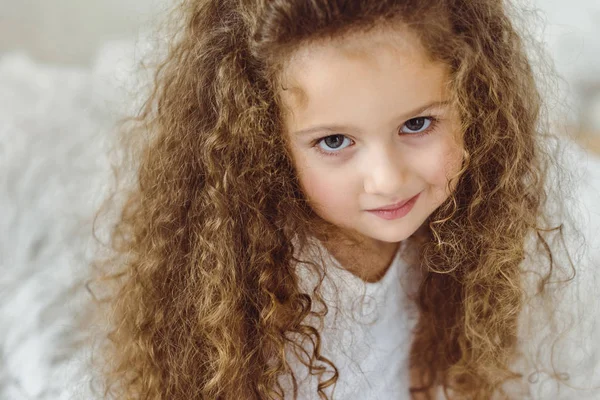 Portrait of adorable curly kid looking at camera — Stock Photo