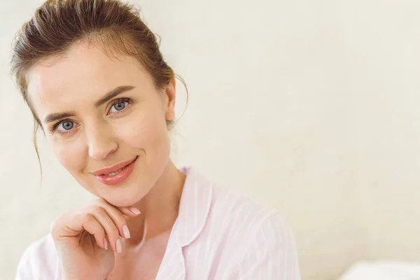 Portrait of charming woman in pajamas looking at camera — Stock Photo