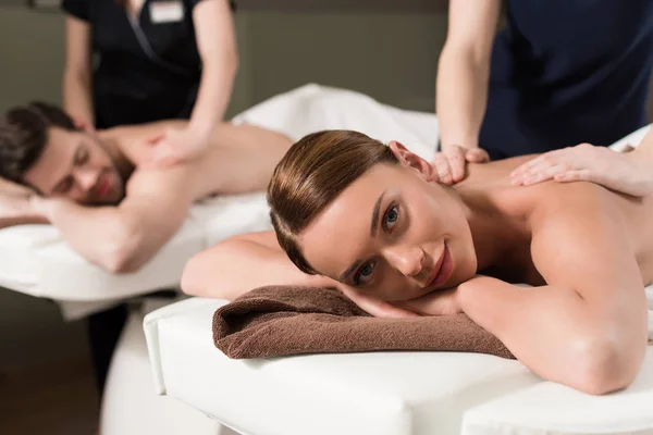 Young couple having massage in spa center — Stock Photo