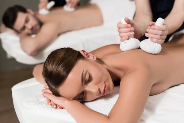 Young couple receiving treatment at spa center — Stock Photo