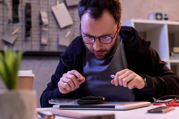 Man in glasses looking on digital tablet on table — Stock Photo