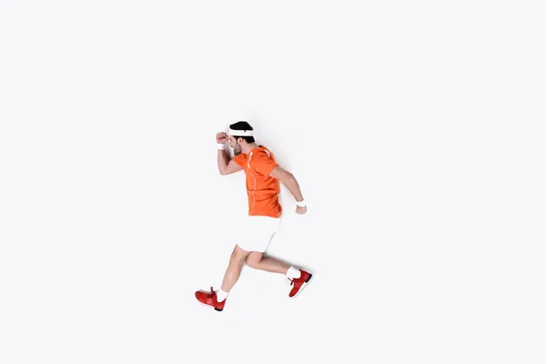 Top view of young man in sportswear running isolated on white — Stock Photo