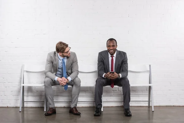 Multiethnic businessmen in suits waiting for job interview — Stock Photo