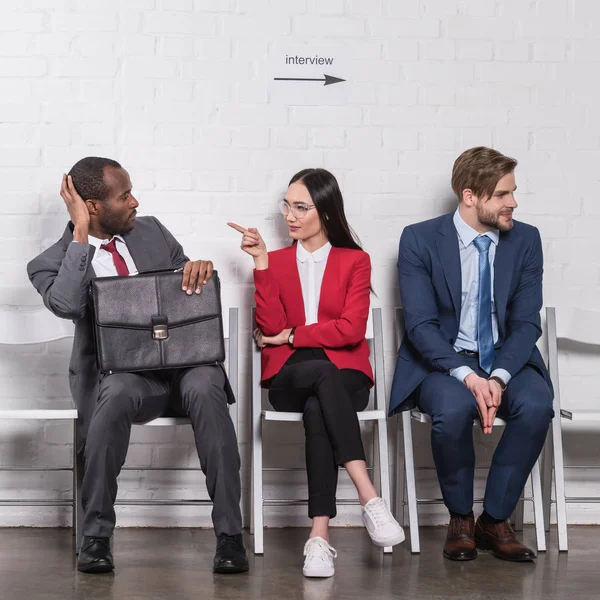 Multiethnic business people sitting on chairs while waiting for job interview — Stock Photo