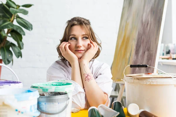 Chica creativa joven soñando en estudio de luz - foto de stock