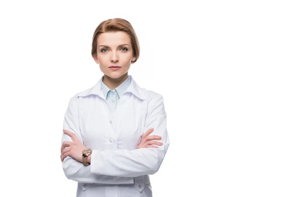 Young attractive female doctor with arms folded isolated on white — Stock Photo