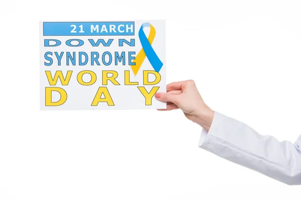 Female hand holding paper with Down Syndrome World Day inscription isolated on white — Stock Photo