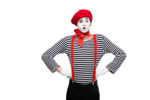 Grimacing mime standing with hands akimbo isolated on white — Stock Photo