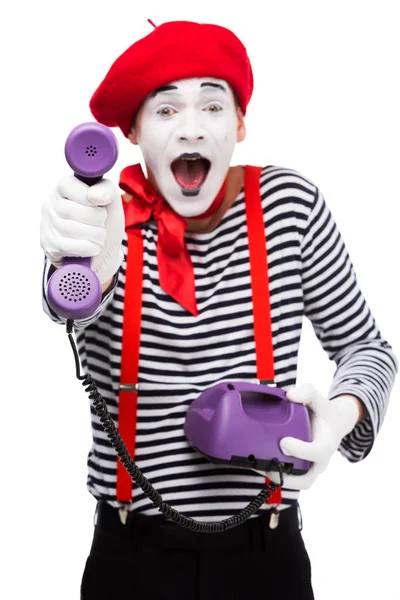 Excited mime giving ultra violet retro stationary telephone isolated on white — Stock Photo