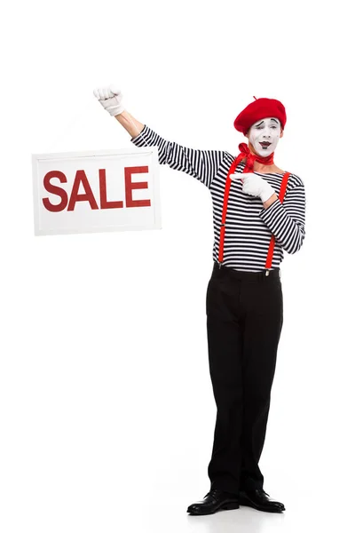 Happy mime pointing on sale signboard isolated on white — Stock Photo