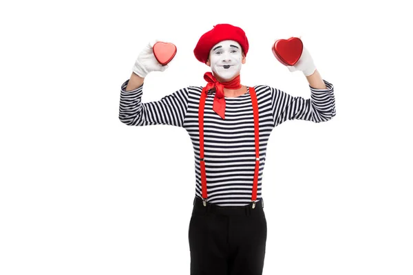 Smiling mime holding heart shaped gift boxes isolated on white, st valentines day concept — Stock Photo