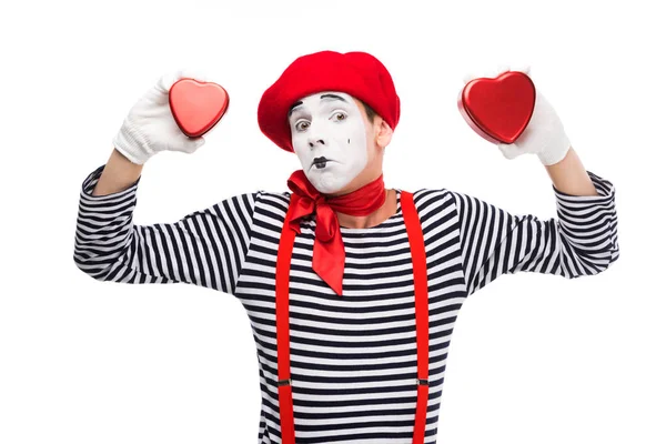 Sad mime holding heart shaped gift boxes isolated on white, st valentines day concept — Stock Photo