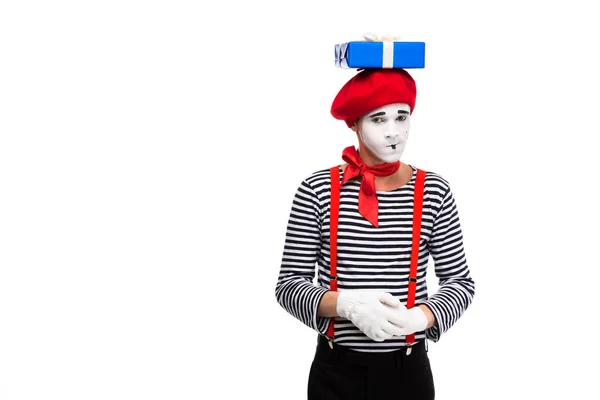 Skeptical mime standing with gift box on head isolated on white — Stock Photo