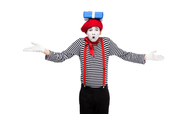 Mime showing shrug gesture with gift box on head isolated on white — Stock Photo