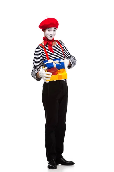 Smiling mime holding gift boxes isolated on white — Stock Photo