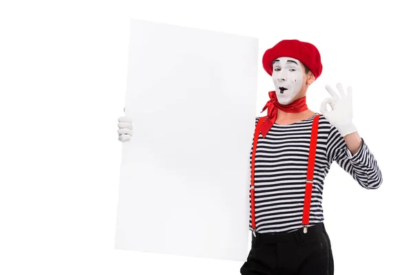 Happy mime holding empty board and showing ok sign isolated on white — Stock Photo