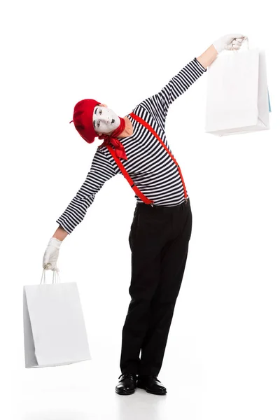 Mime holding shopping bags in open arms isolated on white — Stock Photo