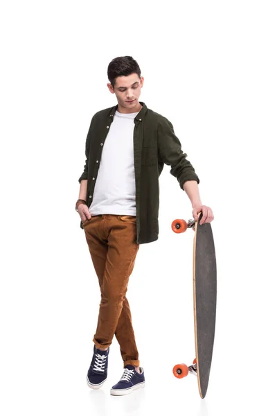 Skateboarder standing with longboard isolated on white — Stock Photo