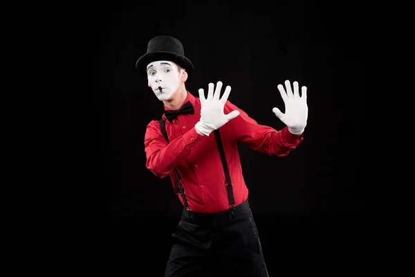 Mime showing stop sign isolated on black — Stock Photo
