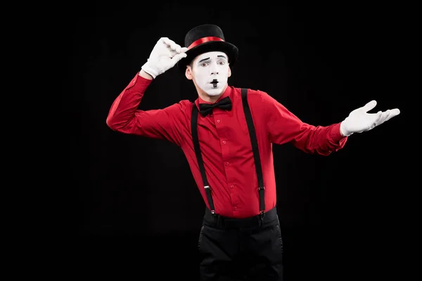 Mime showing shrug gesture isolated on black — Stock Photo