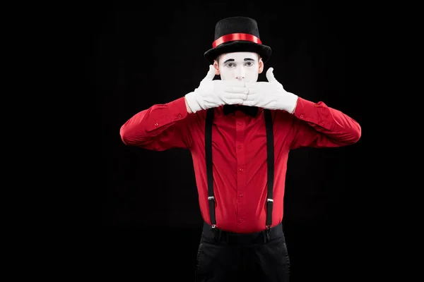 Mime covering mouth with hands isolated on black — Stock Photo