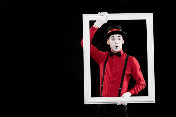 Surprised mime holding frame isolated on black — Stock Photo