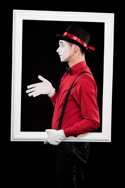 Side view of mime showing hand in frame isolated on black — Stock Photo