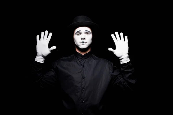 Mime pretending touching something with hands isolated on black — Stock Photo