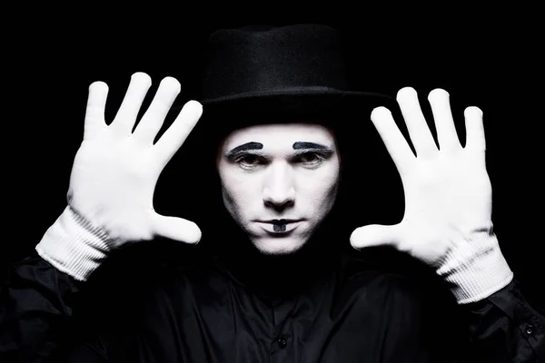 Mime showing hands isolated on black — Stock Photo