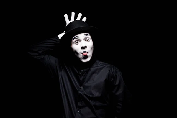 Mime sticking tongue out and grimacing isolated on black — Stock Photo