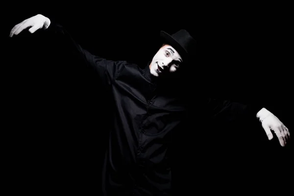 Smiling mime looking at camera and pretending marionette isolated on black — Stock Photo