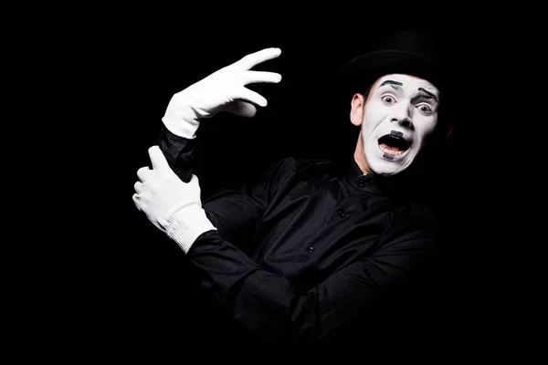 Scared mime with hand monster looking at camera isolated on black — Stock Photo