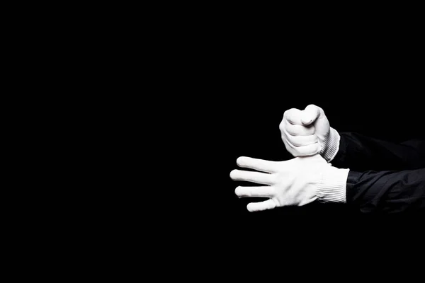 Cropped image of mime hiding thumb isolated on black — Stock Photo