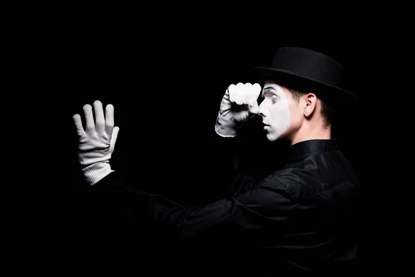 Mime pretending looking in spyglass isolated on black — Stock Photo