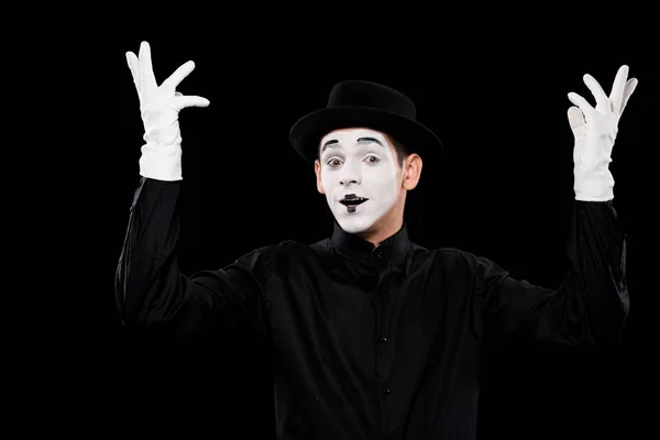 Mime showing hands and looking at camera isolated on black — Stock Photo