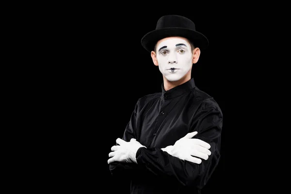 Mime standing with crossed arms and looking at camera isolated on black — Stock Photo