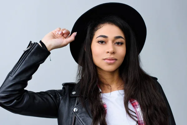 Close-up portrait of beautiful young woman in hat looking at camera isolated on grey — Stock Photo