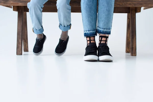 Cropped shot of mother and child sitting on bench together — Stock Photo