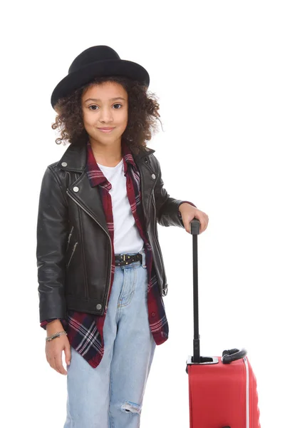 Smiling little child with luggage looking at camera isolated on white — Stock Photo