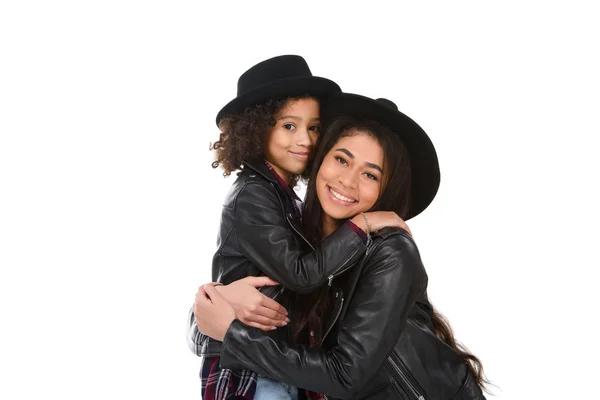 Close-up portrait of happy embracing mother and daughter looking at camera isolated on white — Stock Photo