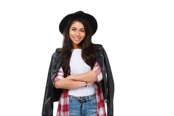 Smiling young woman in stylish clothing and hat with crossed arms isolated on white — Stock Photo