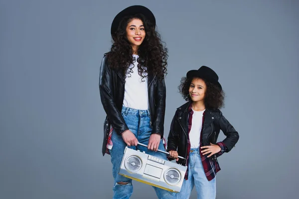 Mother and daughter with retro boombox isolated on grey — Stock Photo