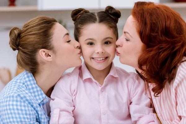 Close-up portrait of granny and mother kissing daughter together — Stock Photo