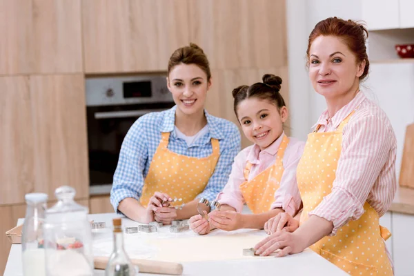 Three generations of women cooking together at kitchen — Stock Photo