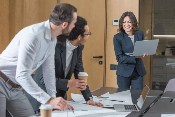 Team of successful architects working with building plans at conference hall of office — Stock Photo