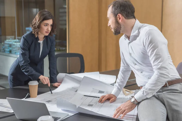 Architects discussing building plans together at modern office — Stock Photo