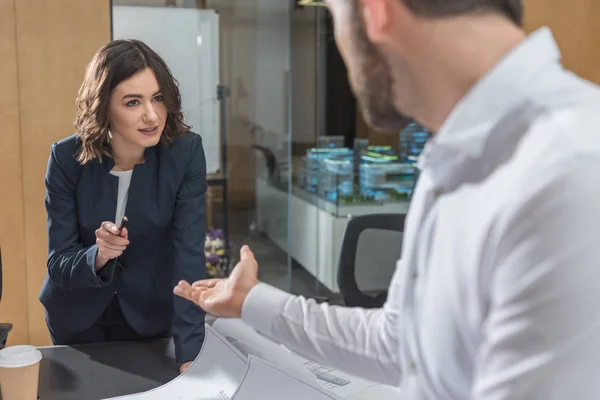 Architects discussing building plans together at office — Stock Photo