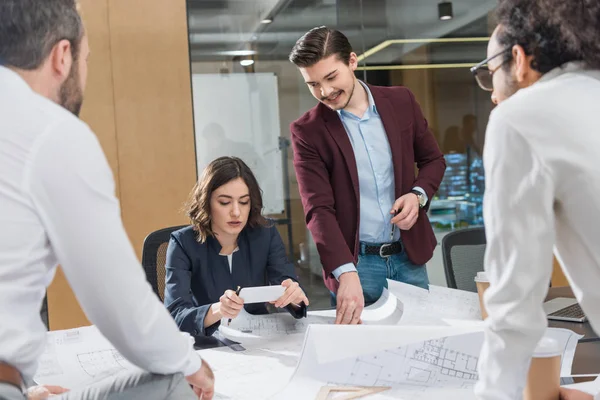 Group of architects working together on building plans at office — Stock Photo