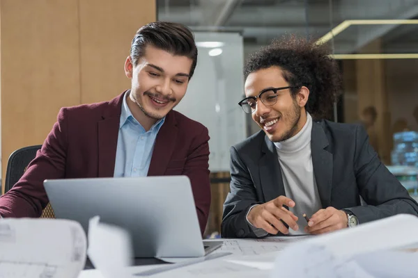 Young architects working with laptop together at office — Stock Photo