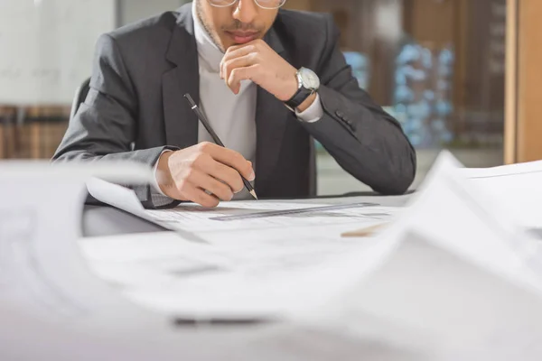 Cropped shot of young architect drawing building plan — Stock Photo